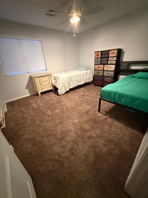 A shared resident bedroom at Marin House with twin beds and a dresser
